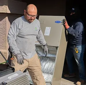 Construction workers installing drywall in a new home