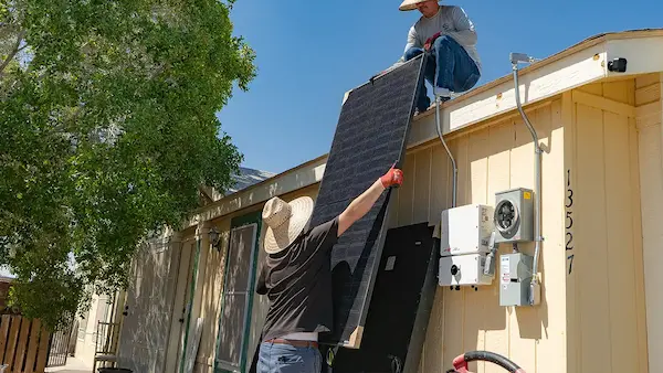 Solar panels covering a large brick house roof