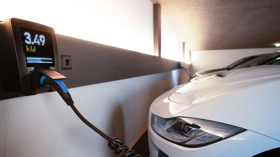 Wall-Mounted EV Charger Charging a Car Inside a Home Garage