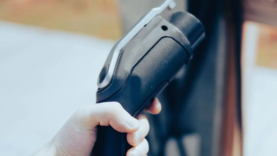 Close-Up of a Hand Holding an EV Charging Connector