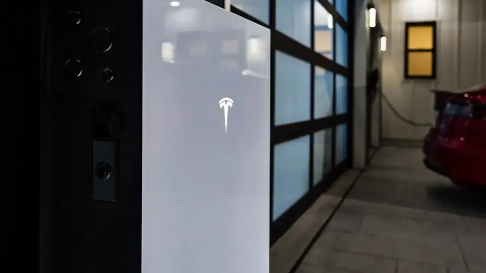 Close-Up of a Tesla Powerwall Installed at a Home Entryway