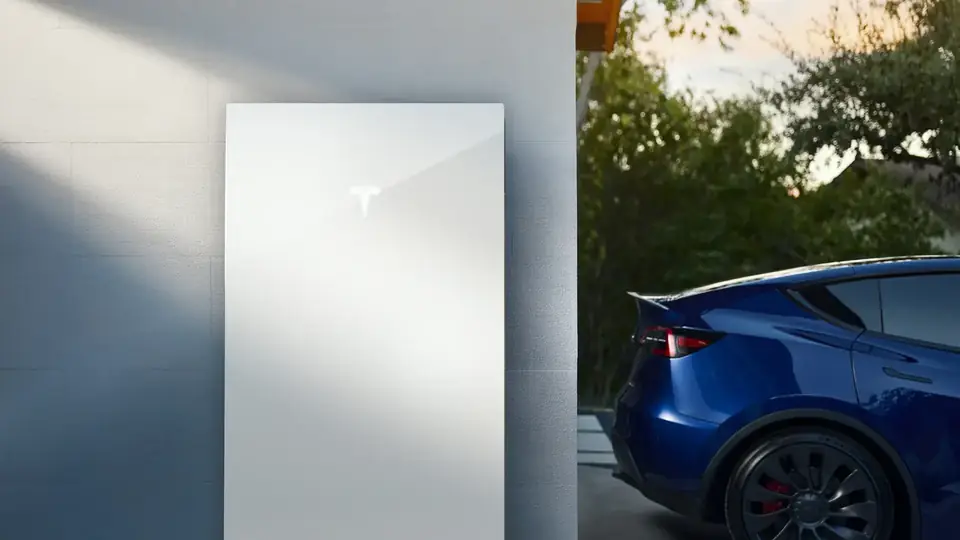 Tesla Powerwall Installed Beside a Tesla Vehicle at a Home