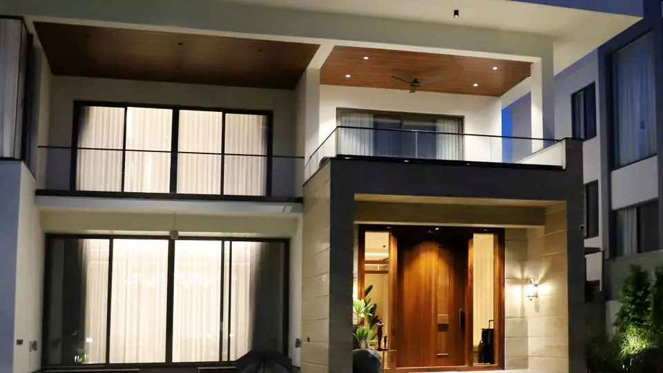 Home With Tesla Solar Roof Illuminated at Night